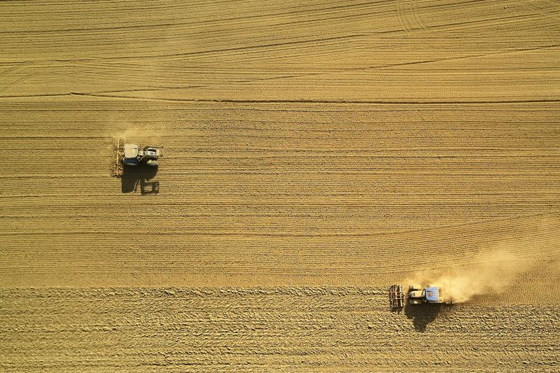Photo by Johny Goverend on Unsplash Tractors harvesting grain field
